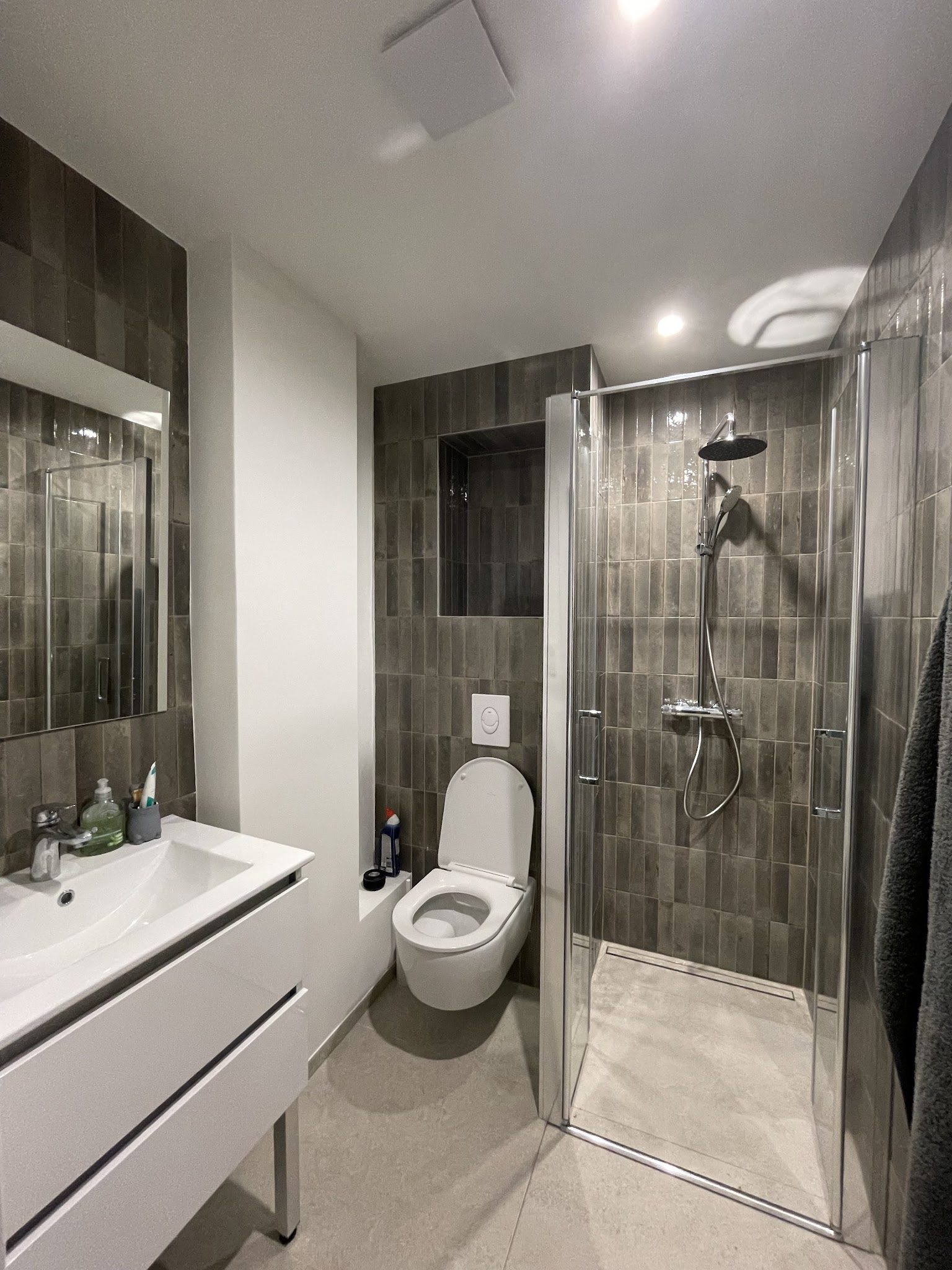 Salle d'eau en grès gris brillant avec niche